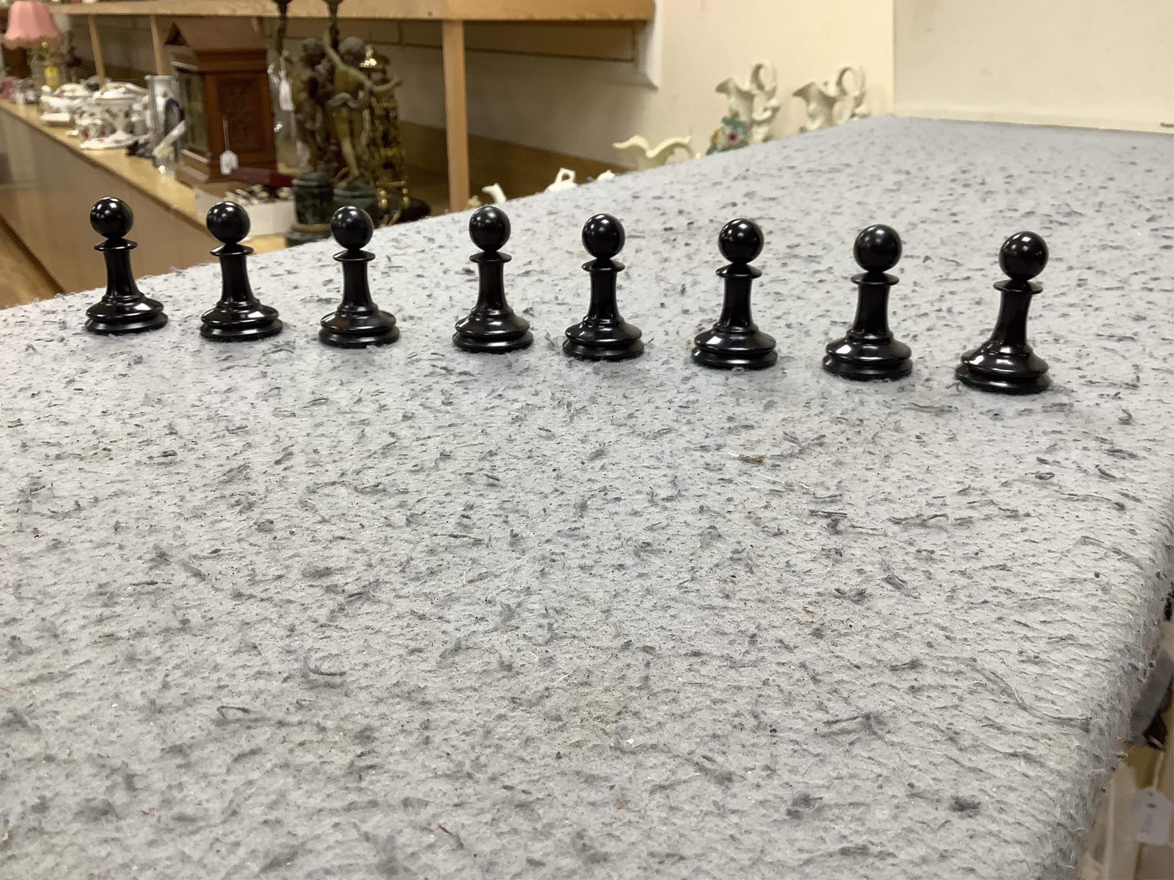 A boxed Jaques Staunton boxwood and ebonised lead weighted chess set, White king stamped Jaques London, Kings 10cm, unlabelled box 20cm wide x 9cm high. Condition - chess pieces good, box cracked